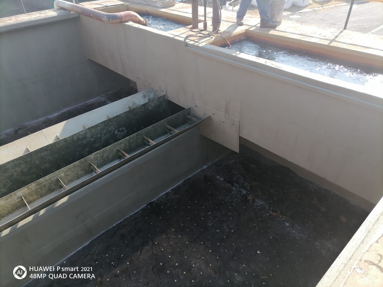 Completed Pressure Washing Cleaning by Delmos Construction Surface showing a freshly pressure washed and cleaned area, highlighting removal of dirt and grime for a restored look