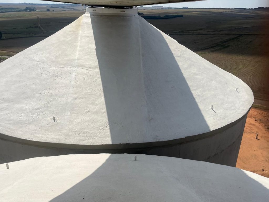 Fresh coat of paint applied to the top of a silo, highlighting clean finish and protective sealing work