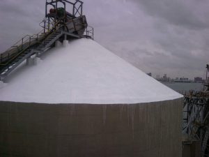 View of the newly painted top section of a concrete silo, showcasing clean, protective coating work