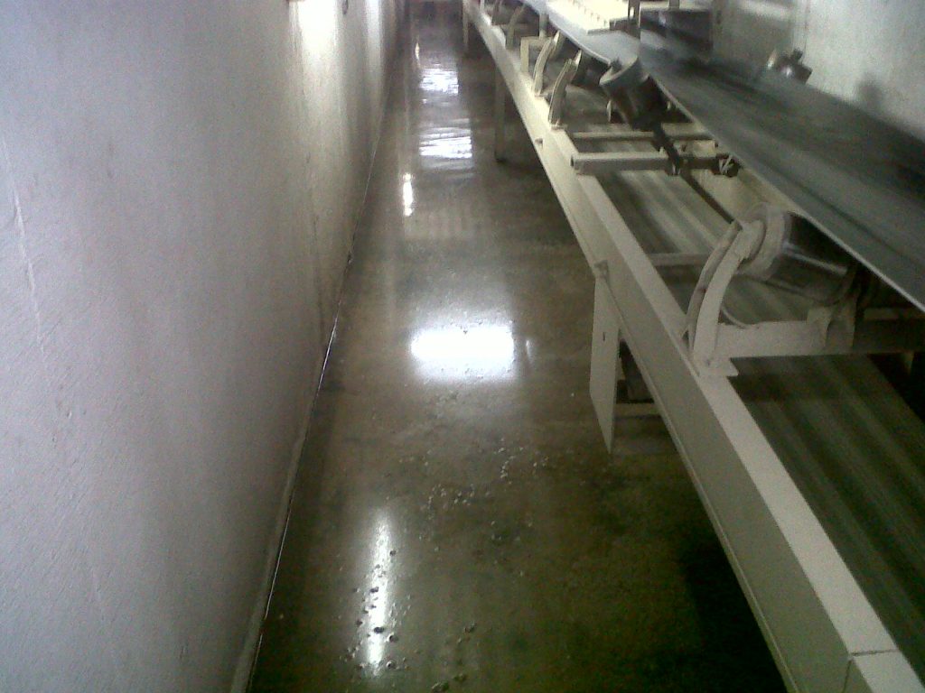 Shiny waterproofing layer applied to an interior floor, providing a protective and sealed surface