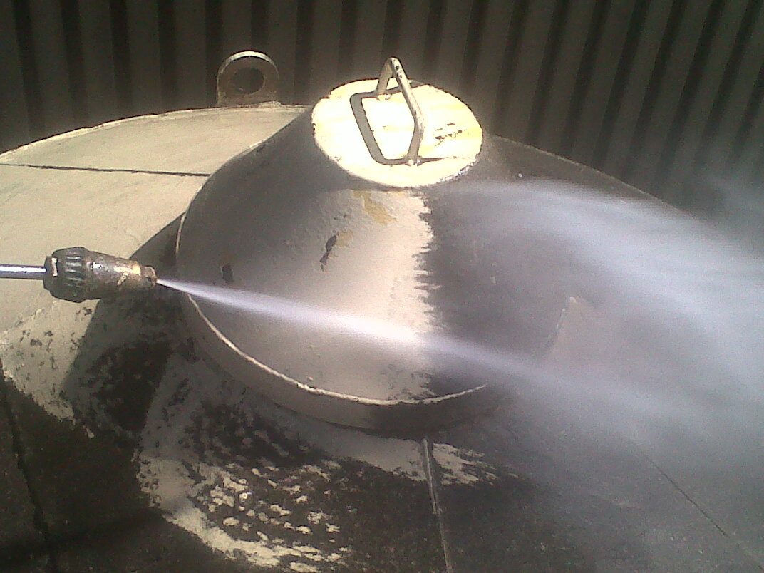 Concrete surface with clear contrast between cleaned side and yet-to-be-cleaned side, demonstrating effectiveness of pressure washing by Delmos Construction